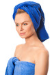 Portrait of young beautiful woman with blue towel after bath