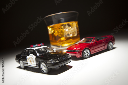 Photo: Police and Sports Car Next to Alcoholic Drink Police and Sports Car Next to Alcoholic Drink