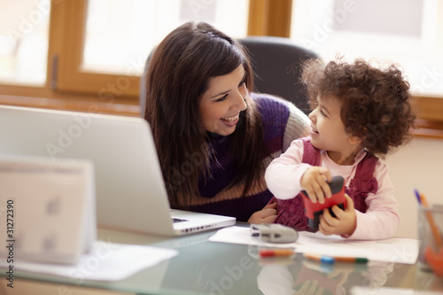 Photo: Multitasking mother with her daughter Multitasking mother with her daughter