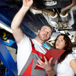 Photo: Motorcar mechanic explaining the engine damage to a customer Motorcar mechanic explaining the engine damage to a customer
