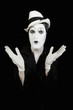 face and hands of mime with dark make-up