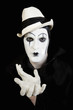 face and hands of mime with dark make-up