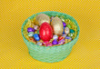 Colorful Easter chocolate eggs in a green basket
