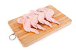 Raw chicken wings on wooden board