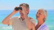 Elderly couple using binoculars