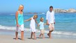 Cute family walking on a beach