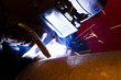 worker weld metal in factory and sparks