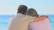 Elderly couple looking at the sea