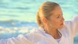 Woman doing stretching excersises on a beach