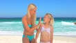 Beautiful mother rubbing suncream on her little girl