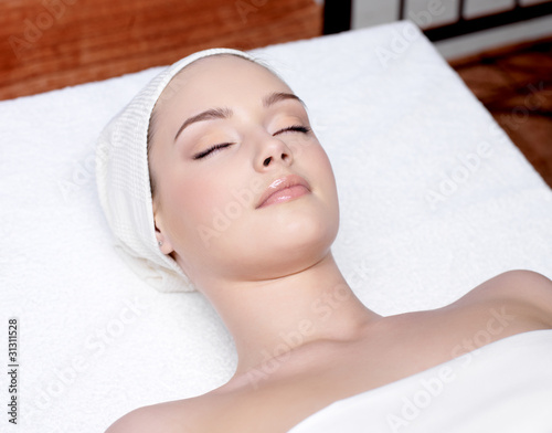 Photo: beautiful woman relaxing in a spa salon beautiful woman relaxing in a spa salon