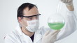 Video: Scientist mixing green liquid in Volumetric Flask Scientist mixing green liquid in Volumetric Flask