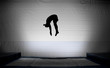 silhouette of jumping man on trampoline doing somersault silhouette of jumping man on trampoline doing somersault