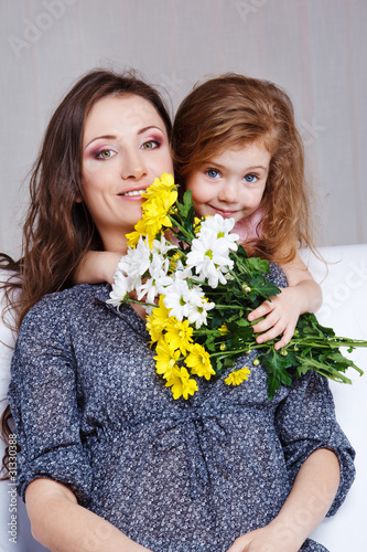 Photo: Girl embracing mom Girl embracing mom