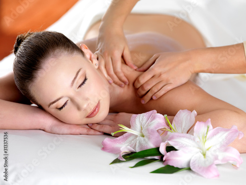 Photo: Spa massage on a shoulder for young beautiful woman Spa massage on a shoulder for young beautiful woman