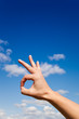 Photo: Hand gesture Ok against blue sky Hand gesture Ok against blue sky