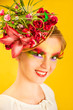 Beautiful young woman with creative flower cap. Artistic makeup