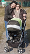 Photo: Happy Family Walking with Stroller Happy Family Walking with Stroller