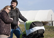 Happy Family Walking with Stroller