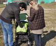 Photo: Happy Family Walking with Stroller Happy Family Walking with Stroller
