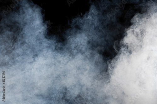 Photo: White smoke on black background. Isolated. White smoke on black background. Isolated.