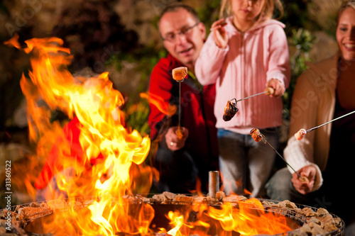 Photo: Family at the barbecue in the evening Family at the barbecue in the evening
