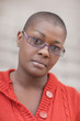 Headshot of a bald woman with glasses Headshot of a bald woman with glasses