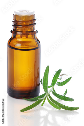 Photo: bottle of aromatic essence oil and fresh rosemary on white isola bottle of aromatic essence oil and fresh rosemary on white isola
