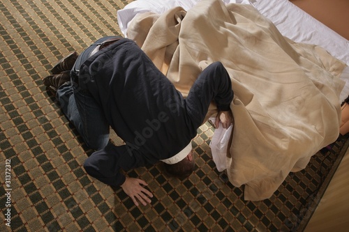 Photo: Man Looking For Something Under The Bed Man Looking For Something Under The Bed