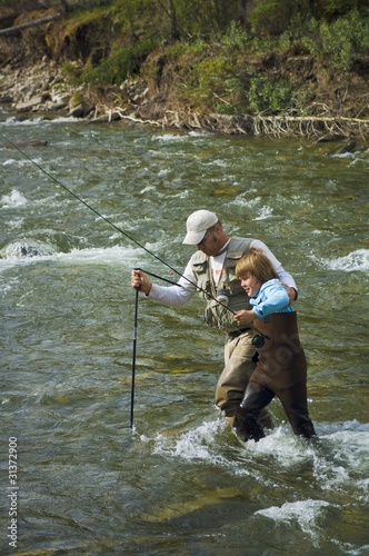 Photo: Father And Son Crossing A Mountain Fly Fishing River Father And Son Crossing A Mountain Fly Fishing River
