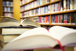 Photo: Reading books in library - education concept Reading books in library - education concept