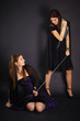 Two young girls playing master and slave