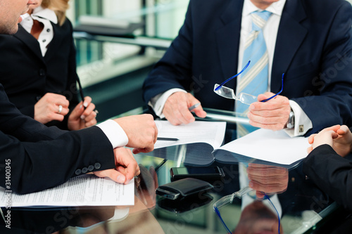 Photo: Business meeting with work on contract Business meeting with work on contract