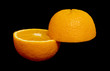 Two halves of orange isolated over black Two halves of orange isolated over black
