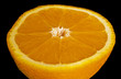 Half of orange isolated over black Half of orange isolated over black