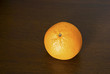Single orange lying on thetable Single orange lying on thetable