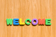 colorful letters with welcome isolated on wood texture colorful letters with welcome isolated on wood texture