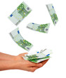 Female's hand and falling euros isolated on white background