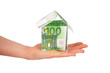 House made from euro bills in female's hand