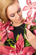 Portrait of young beautiful woman holding flowers