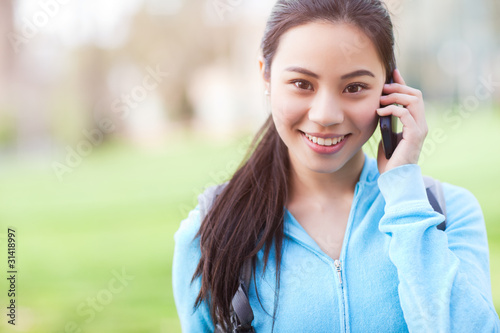 Photo: Asian student on the phone Asian student on the phone