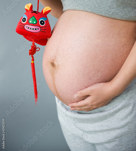 Photo: belly pregnant woman with tiger toy belly pregnant woman with tiger toy