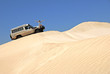 Woman With Off Road Car On Sand Dunes