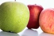 Green and red apples on white background