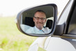 businessman in car smiling at camera