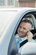 businessman in car talking on mobile phone