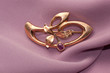 Golden brooch with amethyst