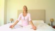 Young woman relaxing with yoga on bed