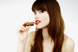 beautiful girl biting a bar of chocolate in a sexy way