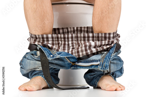 Photo: man is sitting on toilet man is sitting on toilet